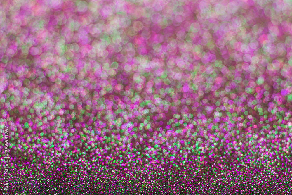 Obraz premium Abstract multicolored glitter background. Green and pink glitter bokeh.