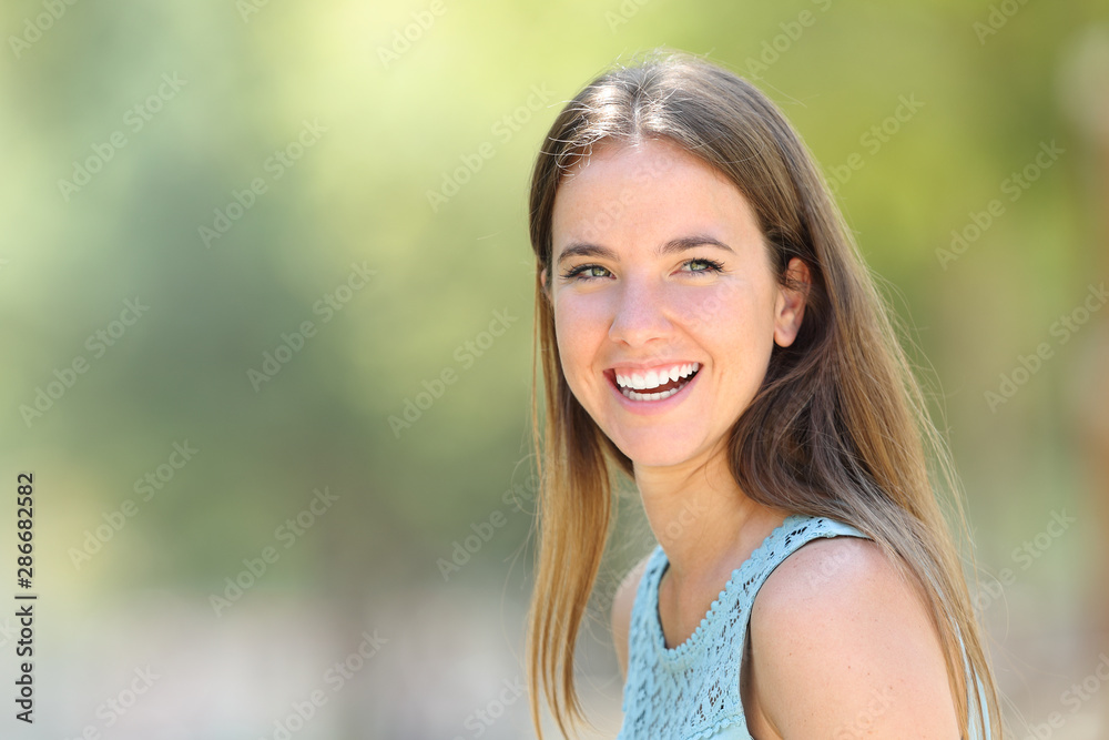 Happy woman with perfect white smile looks away