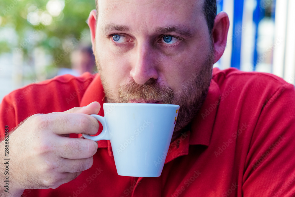 Man drinks coffee on the street. Man drinks coffee. Young man drinks coffee outdoor. Businessman drinks coffee outdoor. Man drink coffee in cafe. Cozy atmosphere. Coffee Man drinks coffee on the street. Man drinks coffee. Young man drinks coffee outdoor. Businessman drinks coffee outdoor. Man drink coffee in cafe. Cozy atmosphere. Coffee
