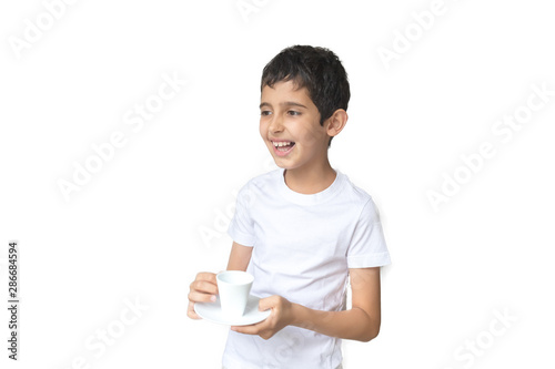 Happy smile boy with white cup in his hands. Teenager holding a cup of coffee. Child with milk or tea. White background.