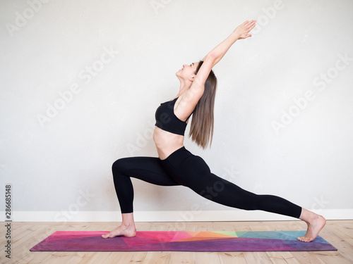 Attractive flexible girl doing yoga exercises