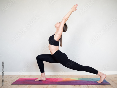 Attractive flexible girl doing yoga exercises