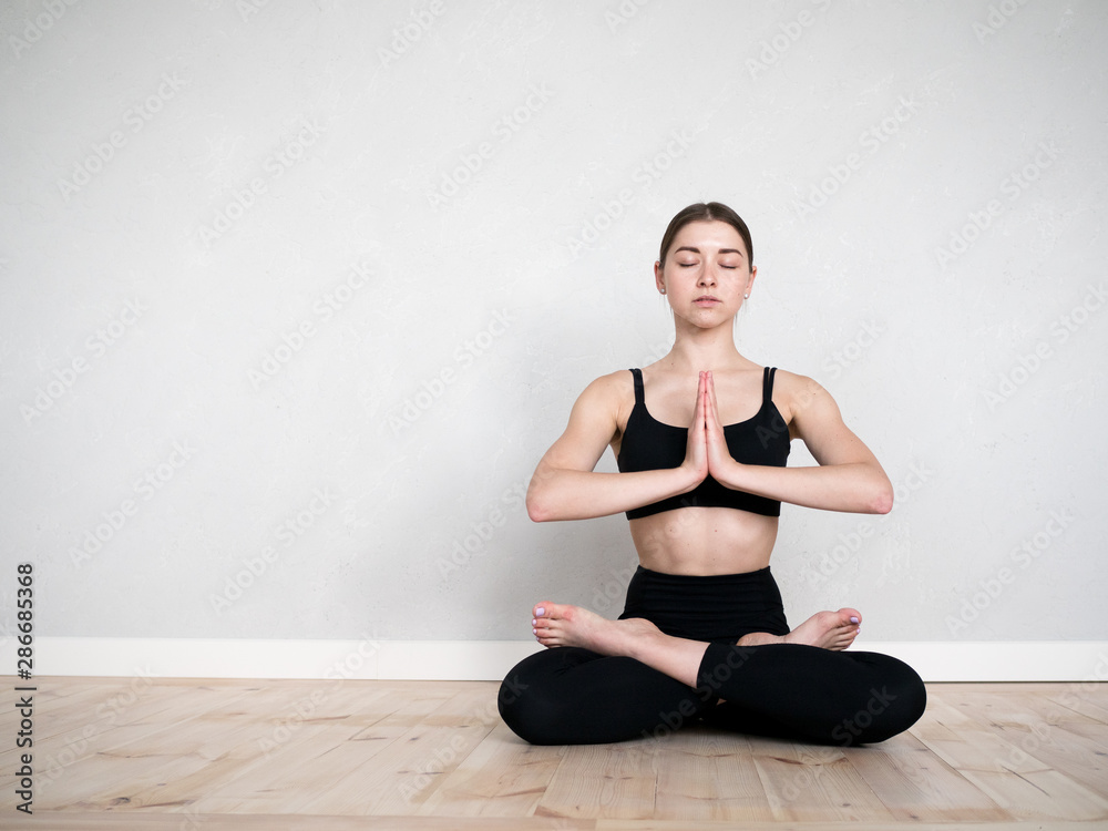 Attractive flexible girl doing yoga exercises