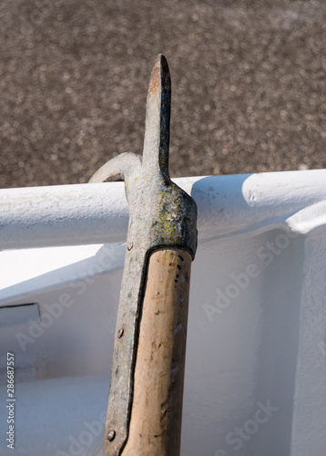 Fotografie Close-up of mooring hook and boat railing.