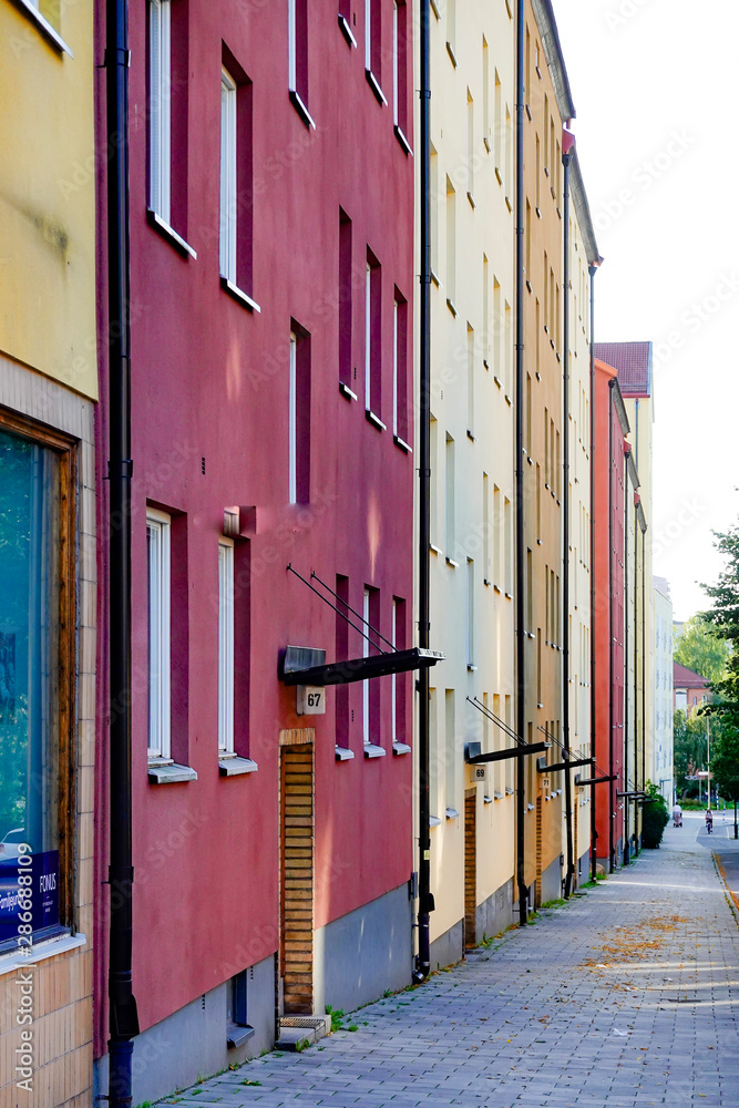 Fototapeta premium Stockholm, Sweden A sidewalk and classic apartment building on Arstavagen in the Arsta suburb.