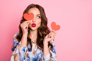 Close-up portrait of her she nice-looking attractive lovely coquettish cheerful cheery wavy-haired girl holding in hands two small little heart sending you kiss isolated over pink pastel background