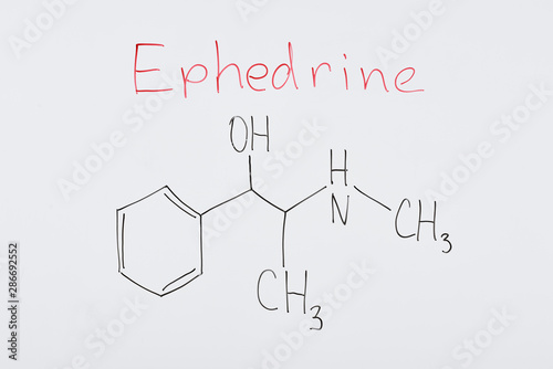 top view of white board with chemical formula and lettering ephedrine