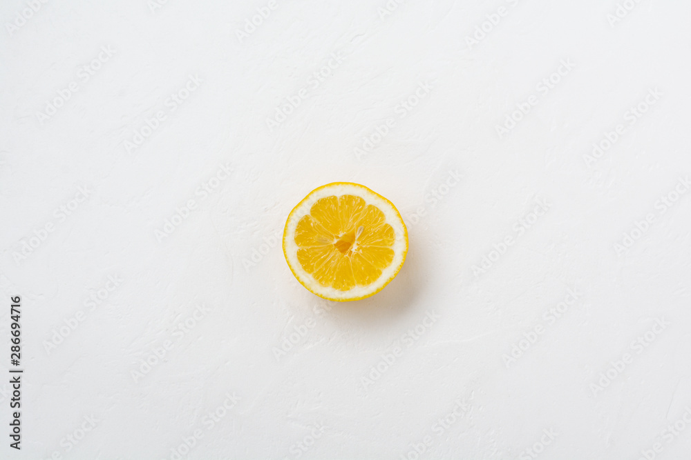 Half lemon on white stone or concrete old background. Top view. Half lemon on white stone or concrete old background. Top view.