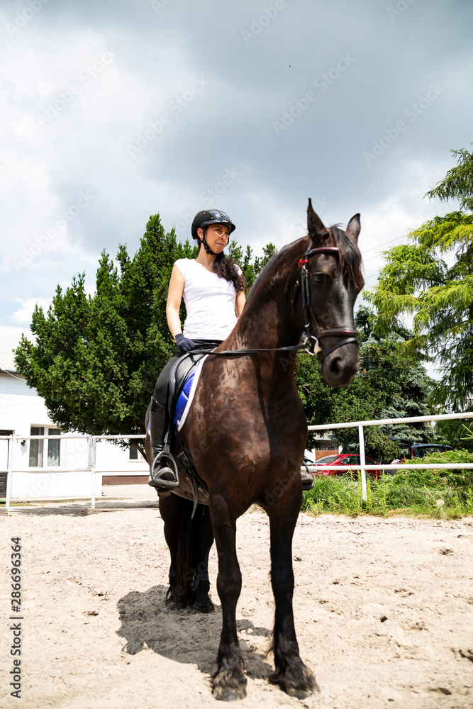 Obraz premium Horse riding. The woman rider rides a horse.