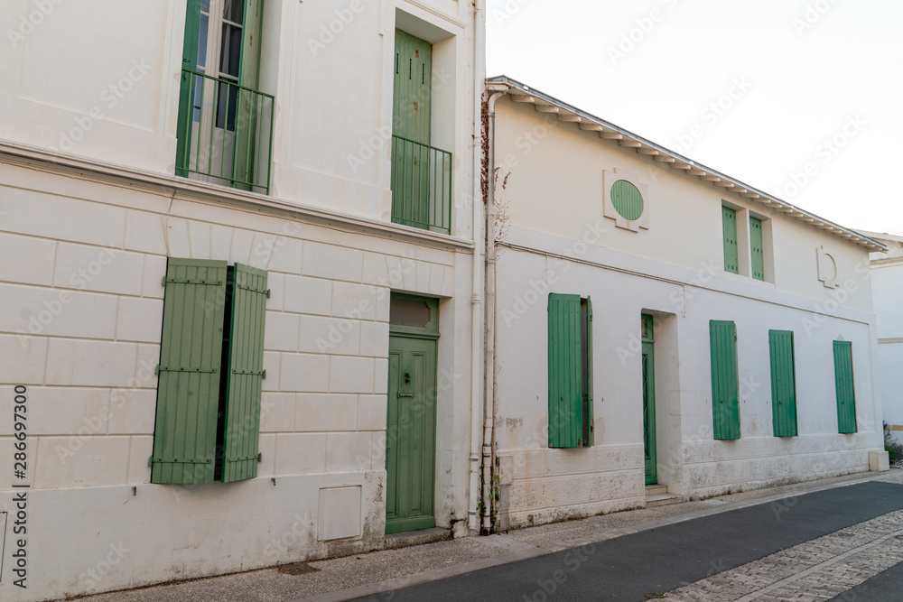 green shutters typical houses of the island of Aix in France green shutters typical houses of the island of Aix in France