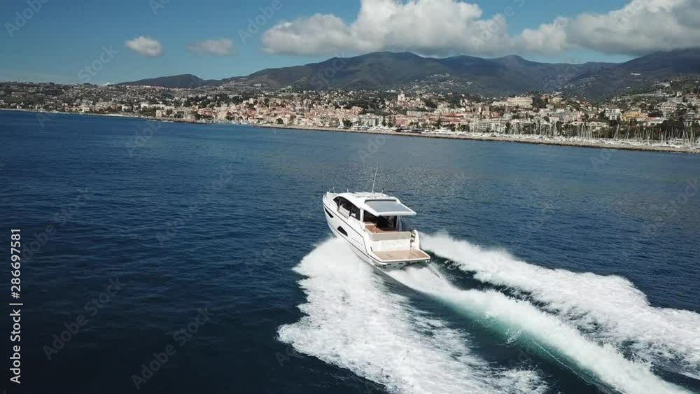 Aerial view of a luxury yacht navigating fast. Aerial view of a luxury yacht navigating fast.
