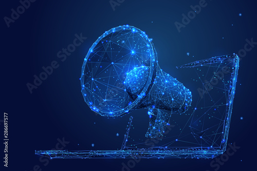 Digital marketing low poly wireframe illustration. Polygonal online notification, Internet targeted advertisement mesh art. 3D laptop and megaphone with connected dots. Promotional campaign photo