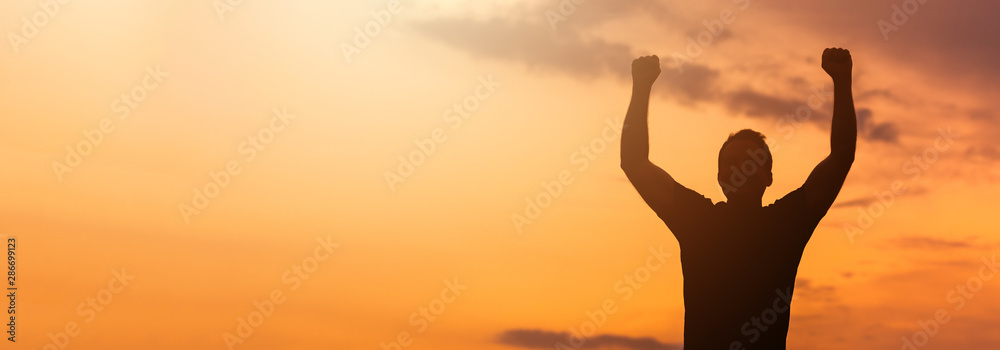 Silhouette of a man with hands raised in the sunset. Silhouette of a man with hands raised in the sunset.