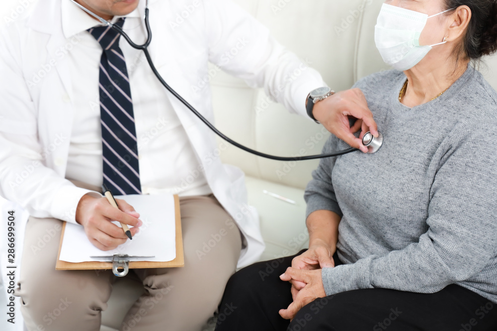 Asian young Doctor talking with Senior woman in hospital Asian young Doctor talking with Senior woman in hospital