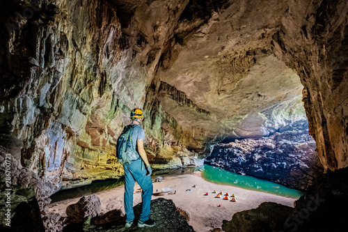 Fotografi Caver overlooking camp in Hang En cave, Vietnam