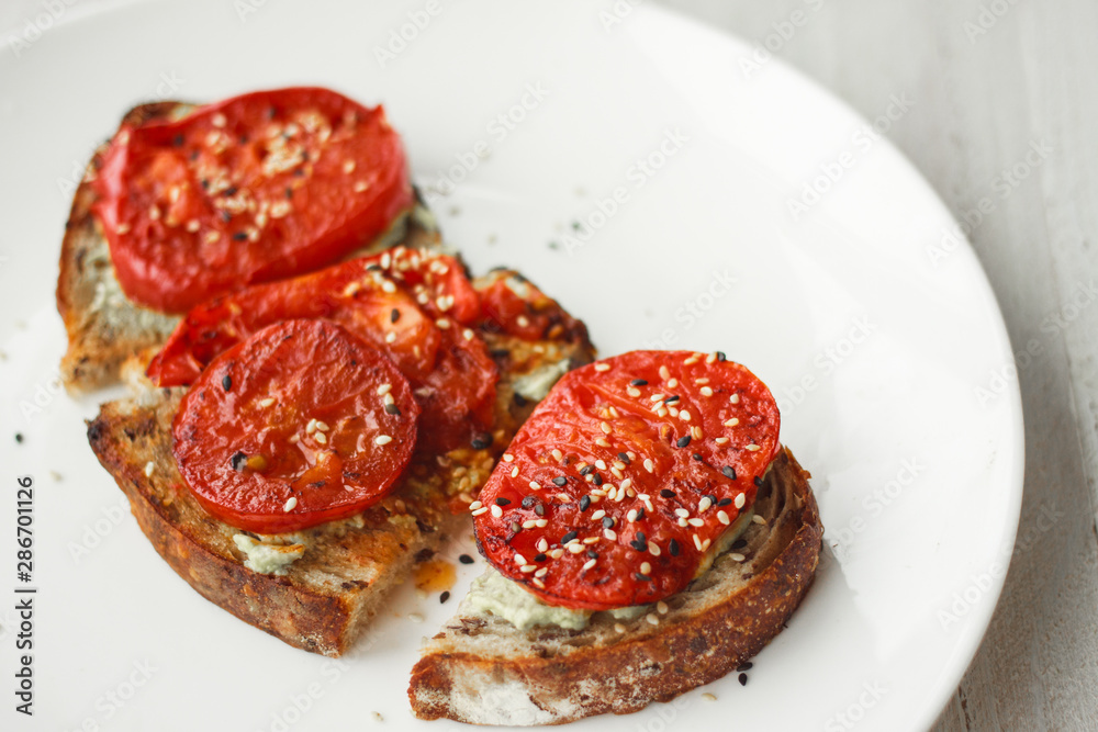 Obraz premium Tasty and healthy.Sandwich with cream cheese and tomatoes for Breakfast.