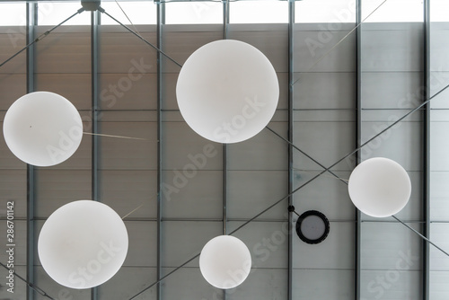 White sphere lamps hanging from ceiling for decoration.