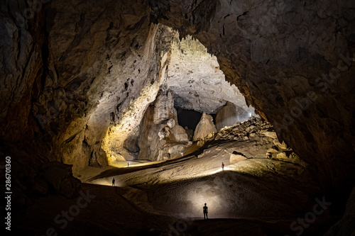 Cavers progressing towards the Great Wall of Vietnam in Son Doong cave, Vietnam photo