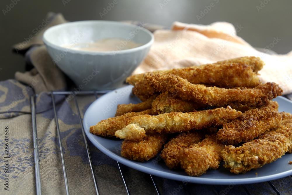 Freshly cooked crispy chicken strips Freshly cooked crispy chicken strips