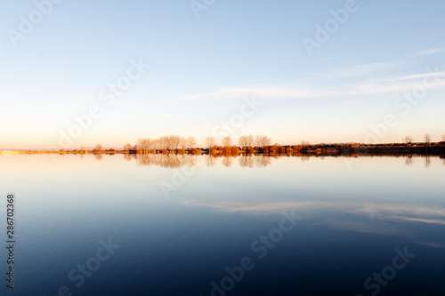 landscape in a lake at sunset © larrui