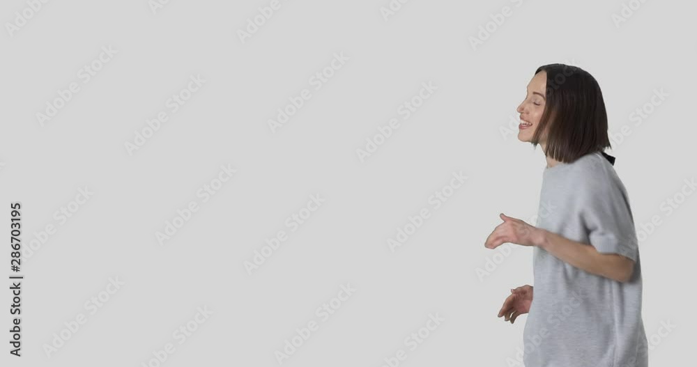 Young woman dancing and walking over white background Young woman dancing and walking over white background