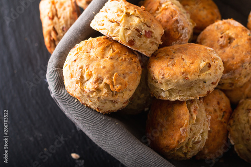 Fotografi Food concept Fresh baked Homemade buttery, salty Ham and cheese scones on black background