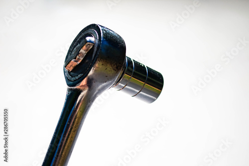 a chrome socket wrench on white background