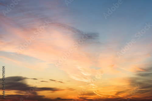 sunset background. sky with soft and blur pastel colored clouds. sunshine through the gradient cloud on the beach resort. nature. sunrise.  peaceful morning © flowertiare