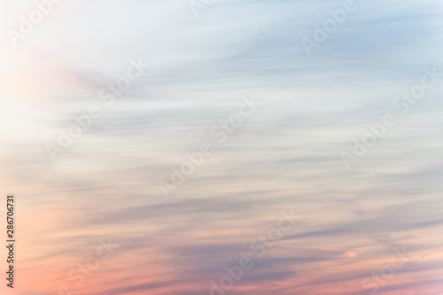 sunset background. sky with soft and blur pastel colored clouds. sunshine through the gradient cloud on the beach resort. nature. sunrise. peaceful morning
