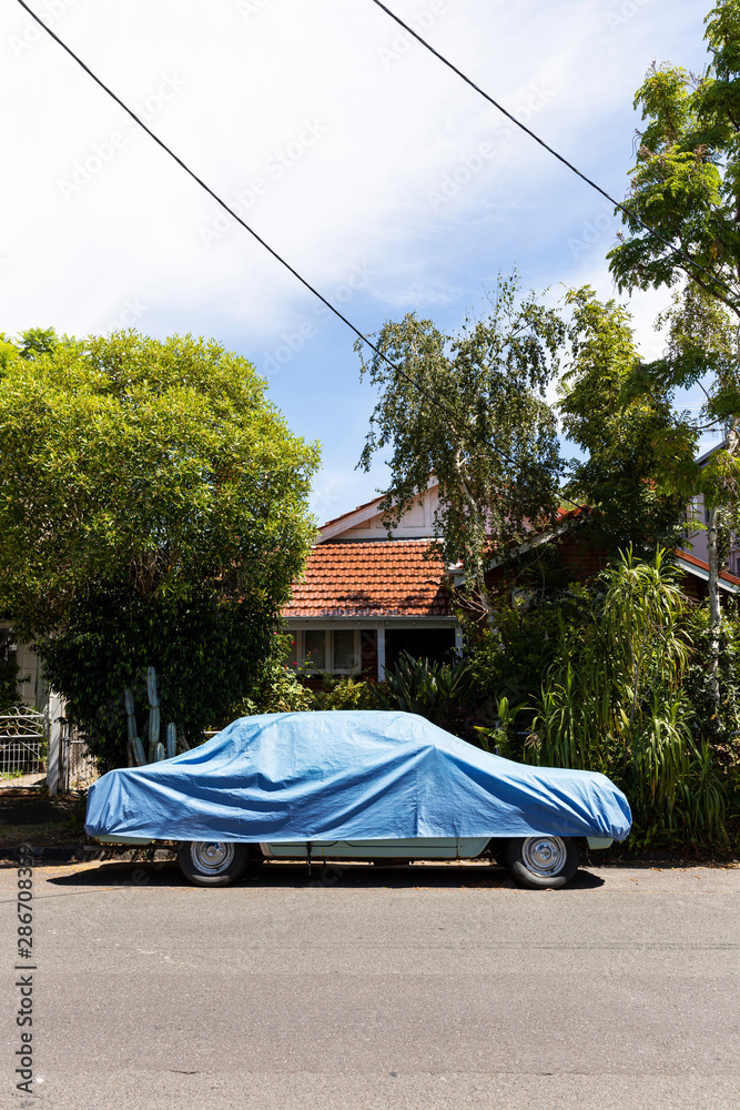 Residential street with car cover placed on top.