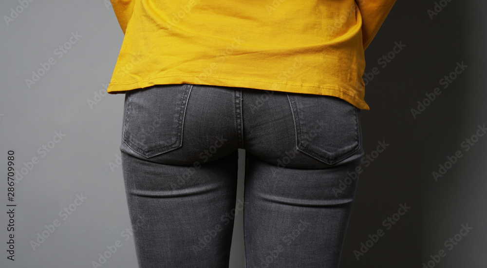 rear view of unrecognizable woman wearing black jeans - female butt or  bottom in tight denim pants Stock Photo | Adobe Stock