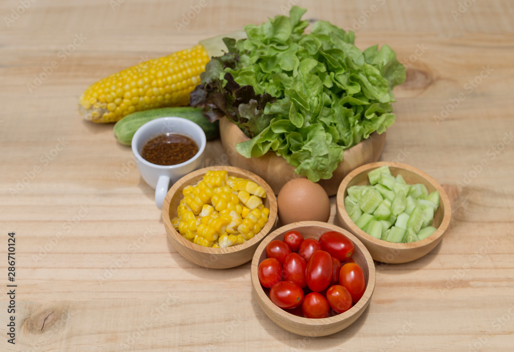 Fresh vegetable in wooden bowl with Japanese salad dressing, healthy diet food concept Fresh vegetable in wooden bowl with Japanese salad dressing, healthy diet food concept