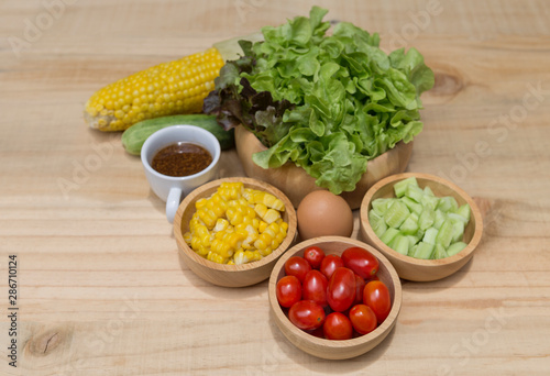 Fresh vegetable in wooden bowl with Japanese salad dressing, healthy diet food concept