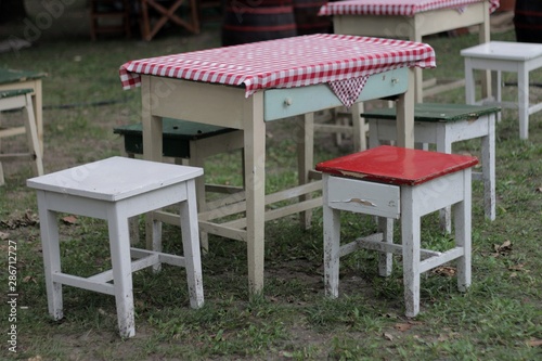 Village table with checkered tablecloth and chairs 02