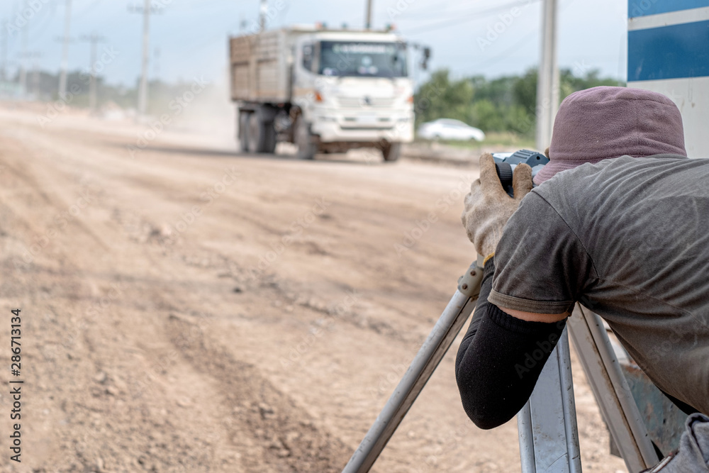 Surveyor engineer using equipment tacheometer or theodolite at road construction site. Surveyor engineer using equipment tacheometer or theodolite at road construction site.