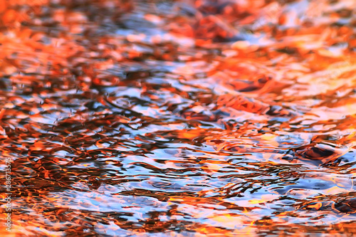 abstract background ripples on water / brown stream, water texture brown color on the swamp, peat