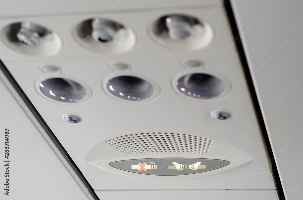 Individual lighting and fans are mounted in panel above passenger seats in cabin. Individual lighting and fans are mounted in panel above passenger seats in cabin.
