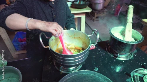 Cooking Chutagi Chhu Tagi in Local Restaurant, Traditional Meal of Ladakh, Under Himalayas Region. Adding Salt Slowmotion photo