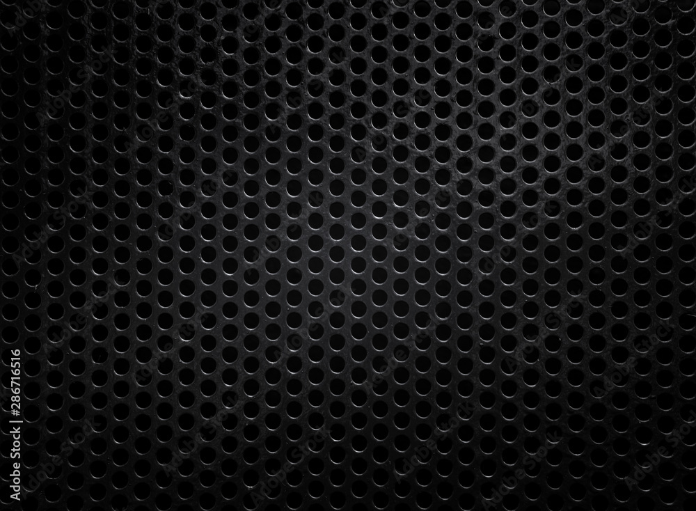 Black metal texture with round holes Black metal texture with round holes