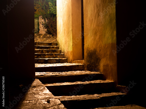 passageway with dimly lit stairs at night photo