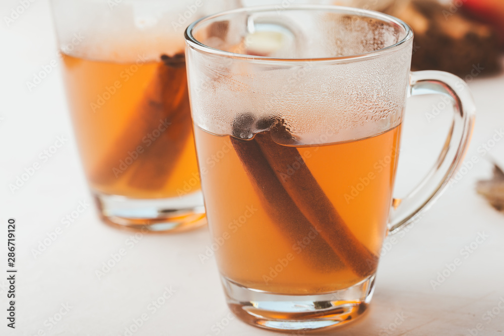 Autumn hot spicy tea glasses with cinnamon sticks Autumn hot spicy tea glasses with cinnamon sticks