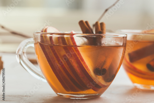 Autumn hot spicy tea glasses with cinnamon sticks photo