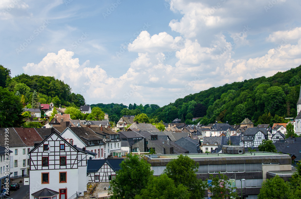View of buildings and church in Blankenheim fron near hills