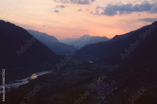 Sunset over layers of misty foggy mountains valley river