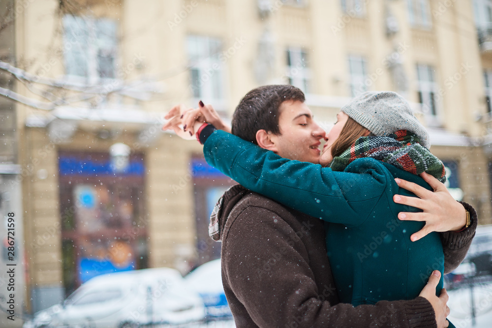 Focus on hands. Happy couple playful together during winter holidays vacation outside in snow park Focus on hands. Happy couple playful together during winter holidays vacation outside in snow park