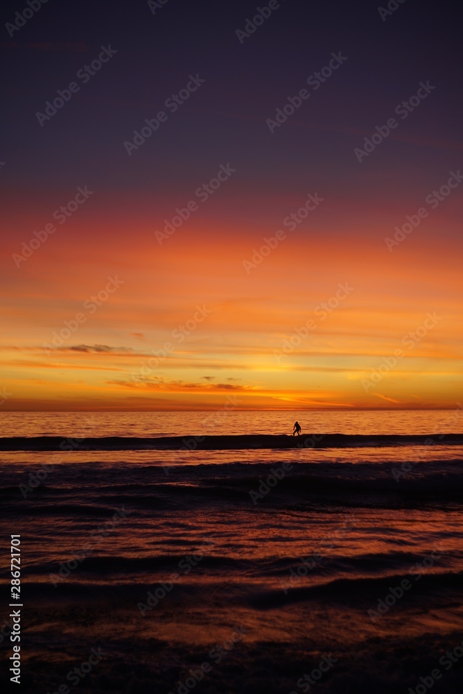 VIBRANT SUNSET WITH SURFERS SPORTS