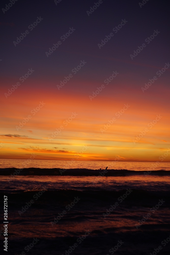VIBRANT SUNSET WITH SURFERS SPORTS