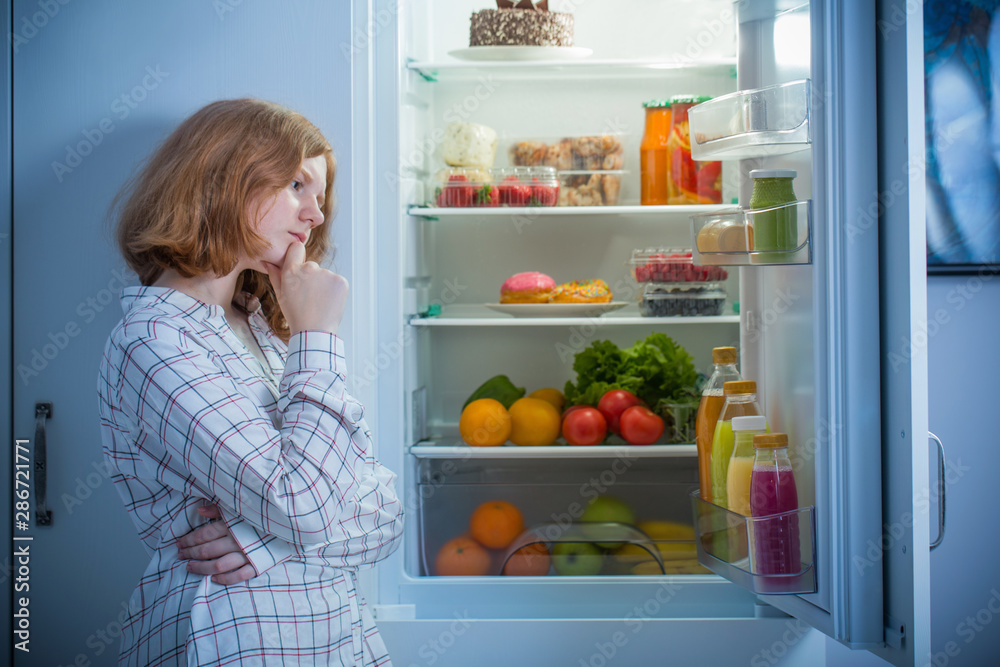 teenager girl at fridge with food teenager girl at fridge with food