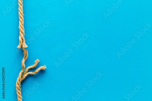 risk concept with rope near to break on blue background top view space for text