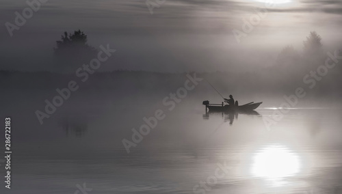 Sunrise with the mist above a river, sport fishing at dawn, summer landscape,...